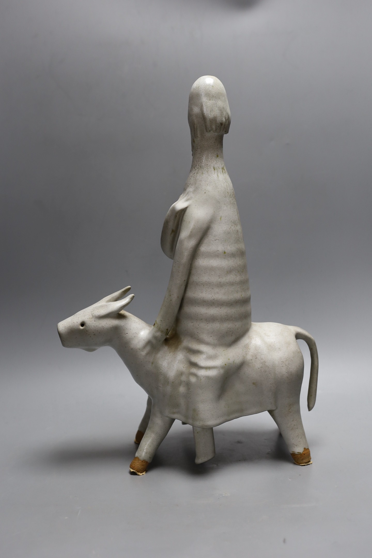 An abstract studio pottery figure of man on a donkey. 43cm high